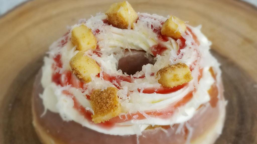 Manchego Cheesecake · Our cheesecake doughnut made with real cheesecake pieces, strawberry sauce and manchego cheese.