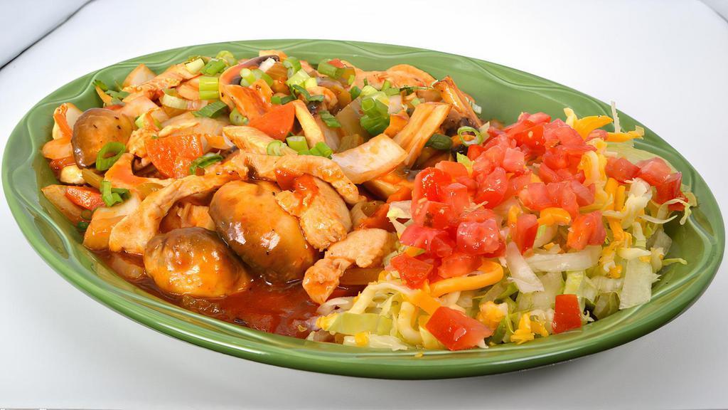 Arroz Con Pollo · Tender strips of fresh chicken breast sautéed in a special sauce with mushrooms, green onions, and tomatoes – served over a bed of rice and melted cheese (not served with beans).