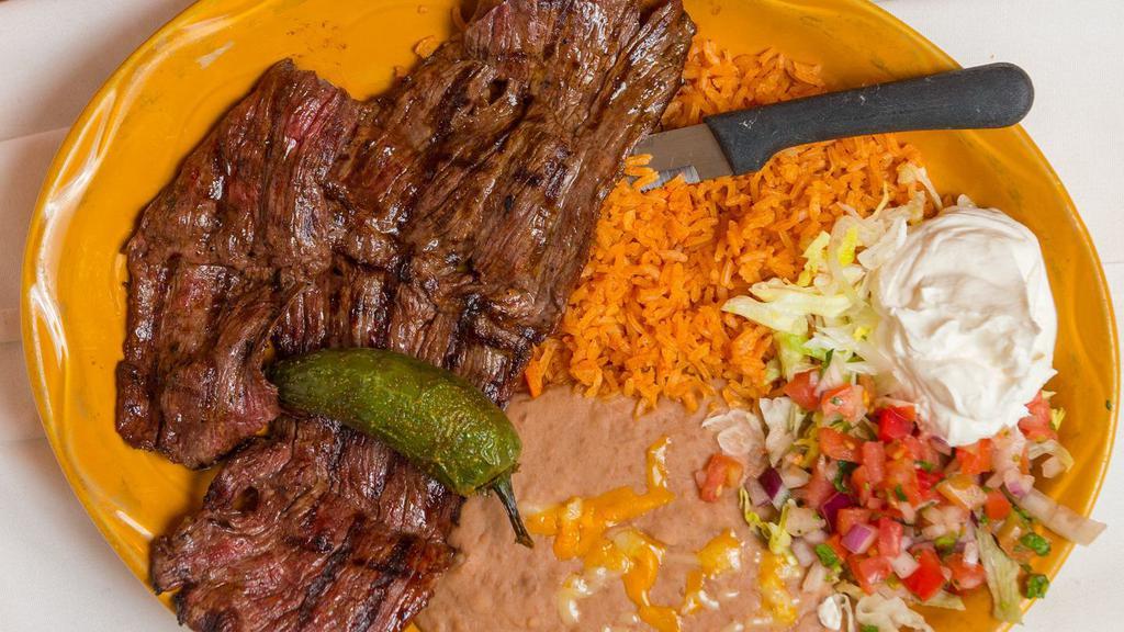Carne Asada · Thinly sliced and seasoned skirt steak or chicken breast carefully charbroiled to perfection – garnished with lettuce, pico de gallo and sour cream – served with rice, beans, and tortillas.