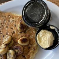 Banana Nut Pancakes · 3 fluffy pancakes with pecans and caramelized bananas . Comes with 2 eggs cooked your way an...