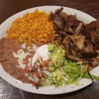 Carnitas · Specially seasoned cooked pork with grilled onions.
