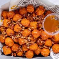 Sweetpotatoes Tat-Tots/ Pecan Fries · Sweet Potato tater-tot are cooked to perfection' then garnish with Famous cinnamon-caramel s...