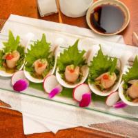 Yellowtail Jalapeno Appetizer · Generous slices of yellowtail topped with a slice of jalapeno chili peppers, cilantro and po...