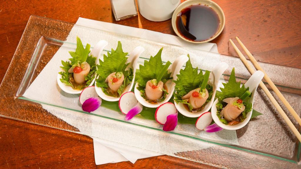Yellowtail Jalapeno Appetizer · Generous slices of yellowtail topped with a slice of jalapeno chili peppers, cilantro and ponzu sauce.