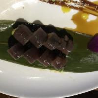 Shogun Roll · Salmon, avocado and crab meat wrapped in seaweed; covered with tuna and topped with ponzu sa...