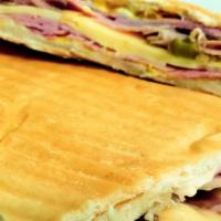 Cubano Sandwich · Buttered cuban bread toasted with serrano ham pressed leg swiss cheese yellow mustard and cu...