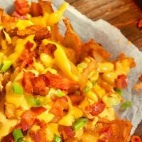 Loaded Fries · Seasoned fries topped with our three cheese fries and bacon bits