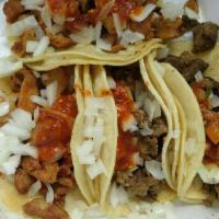 Taco Plate · Three tacos with choice of meat, onions, salsa and cilantro. Served with rice and beans.