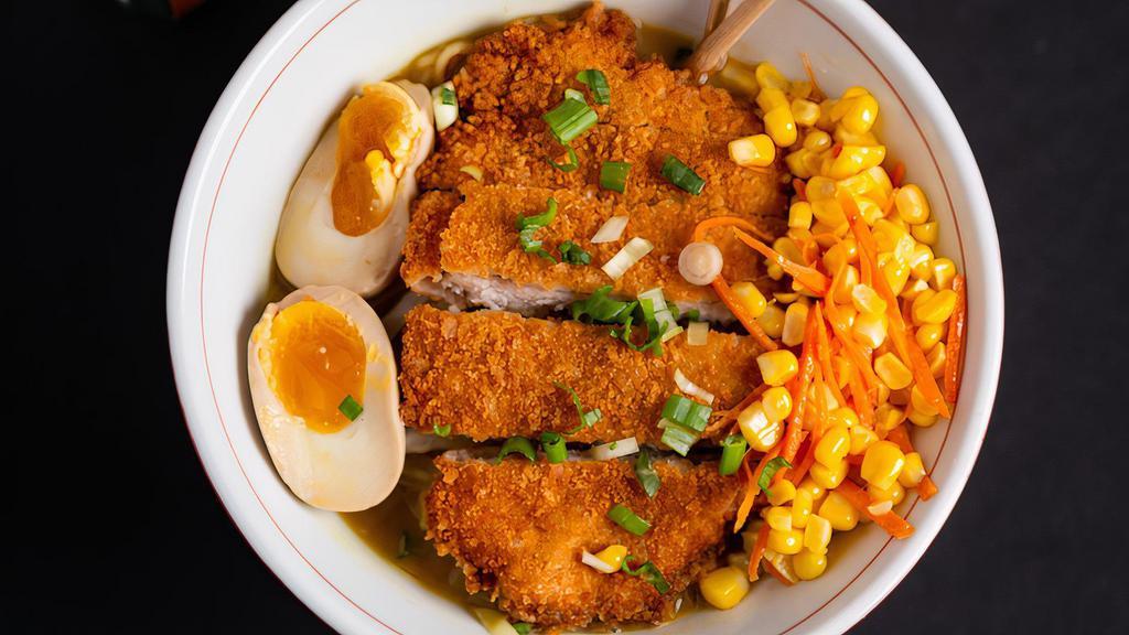 Katsu Curry Ramen · Rich pork and chicken curry broth topped with sautéed cabbage, carrots, corn, chopped spring onions, * soft boiled eggs topped with fried Panko- crusted pork cutlet.