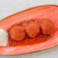 Polpette (Italian Meatballs) · Blend of beef and pork simmered in tomato sauce served with ricotta cheese.