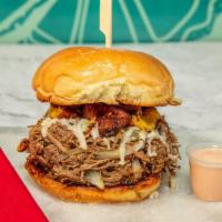 La Vaca · Marinated crispy seared beef with grilled onions, sweet plantains, and mozzarella in a burge...