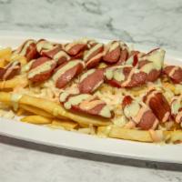 Salchipapa · Deep fried beef frank on a bed of French fries, topped with mozzarella cheese and homemade s...