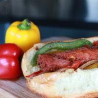 Choripan · Chorizo sausage with sautéed peppers and grilled onions topped with chimichurri on a soft bu...