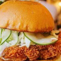 Crispy Chicken Sandwich · Cracked Sauce, House Made Slaw and Pickles, Handmade Brioche Bun served with French Fries