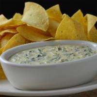 Spinach Queso & Chips · Melted cheese, artichoke, jalapeno, spinach, sundried tomatoes