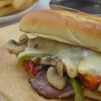 Smoked Brisket Philly · Green peppers, onions, mushrooms, roasted tomatoes, provolone, au jus, fries
