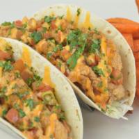 Voodoo Chicken Tacos · Crispy tenders, spicy aioli sauce, shredded cabbage, cilantro, pico de gallo, corn creme bru...