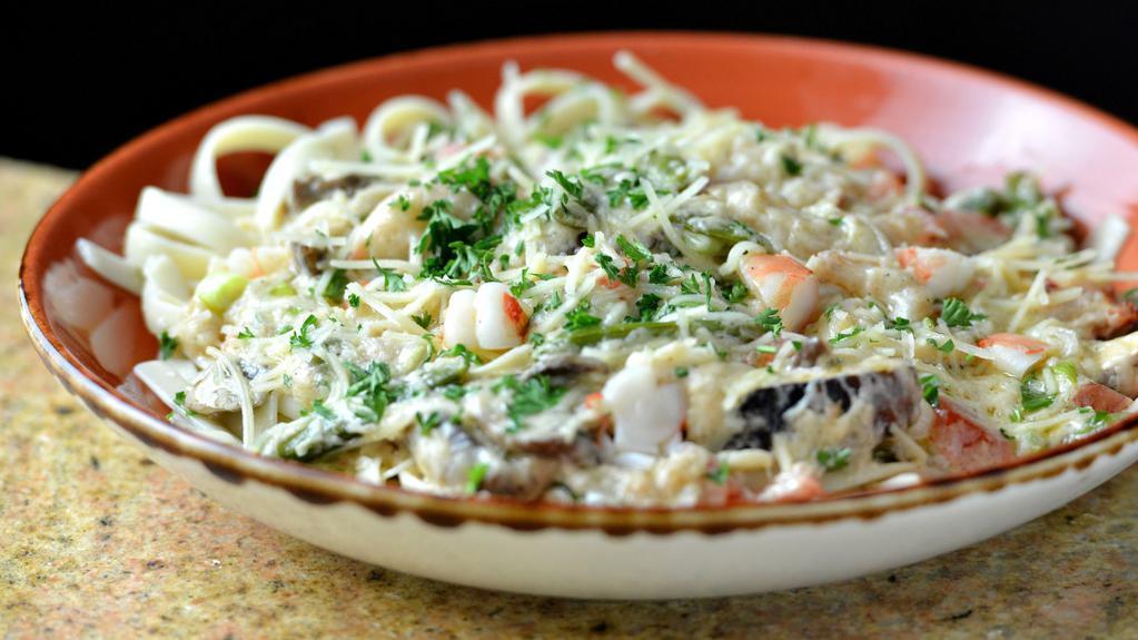 Seafood Fettuccine Alfredo · Lobster, crab, shrimp, snap peas, mushrooms, tomato, green onion