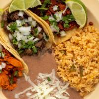 Taco Plate · 3 tacos choose meats. Corn tortillas  Cilantro and onion
 Served with rice/beans and a can s...