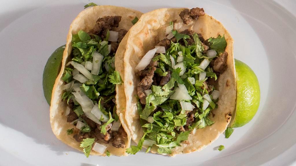 Tacos · Served  with Cilantro, onion and lime
