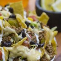 Nachos · Start off with our mouthwatering nachos, then add your choice of protein, beans and all the ...