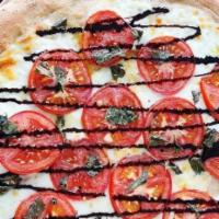 Caprese Pizza · Margherita sliced fresh mozzarella sliced tomato and basil.
