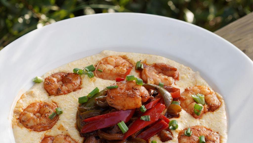 Shrimp & Grits · Large shrimp sautéed with sauce picante, served over a pimento cheese grits with sauce picante.