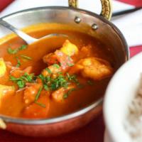 Shrimp Curry · Mildly spiced with turmeric, onion, ginger, garlic, coriander, and cumin --- in a special cu...
