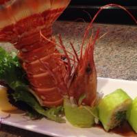 Dancing Shrimp Roll · Shrimp tempura topped with steamed shrimp and avocado with eel sauce.