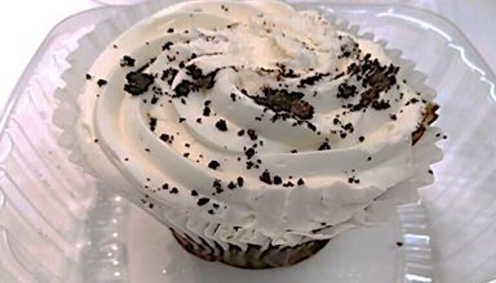 Oreo® Cookie Cupcake · A rich chocolate cupcake topped with vanilla cream and real OREO® cookie bits.