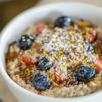 Overnight Oats · Just oats, almond milk, chia seeds, topped with honey, cinnamon, strawberries, blueberries, ...