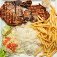 Chuleta De Cerdo Asada · Grilled Pork Chops served with your choice of rice, coleslaw, and one side.