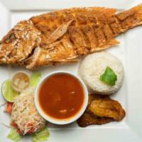 Pescado Frito · Fried Snapper served a homemade tomato sauce,  your choice of rice, coleslaw, and one side.
