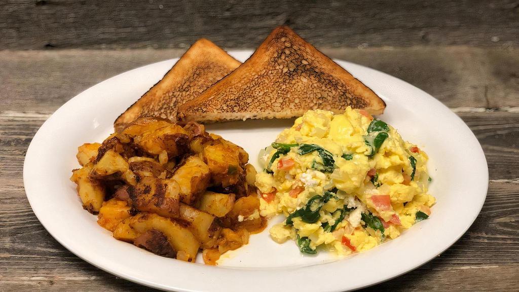 Greek Scramble · scrambled eggs, feta, spinach, onions, tomato, homefries, white toast with butter