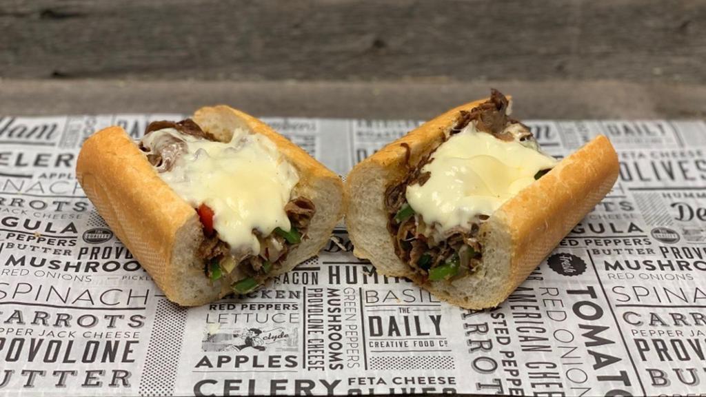 Philly Tribune Cheese Steak · baguette, grilled steak, sauteed onions & peppers, melted provolone