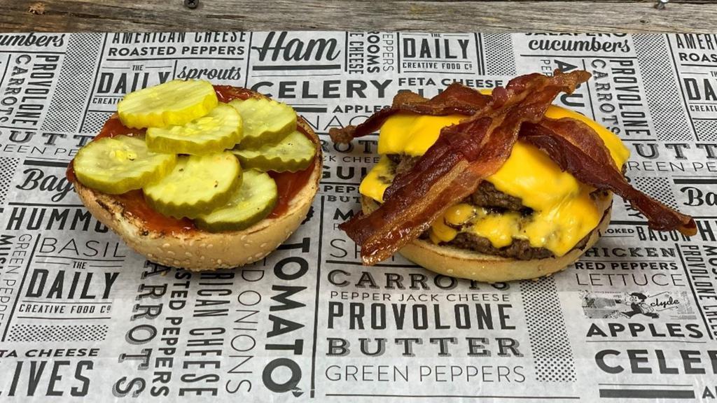 Classic Cheeseburger · toasted sesame brioche bun, two 5oz burger patties, american cheese, applesmoked bacon, ketchup, pickle chips