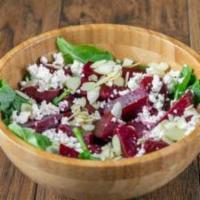 Field Of Beets Salad · Beets, feta, red onions, basil, and almonds on a bed of mixed greens with balsamic dressing.