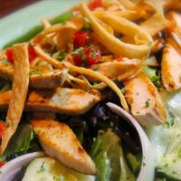 Ensalada Con Pollo · Grilled chicken strips over spring mix and iceberg lettuce with tomatoes, green peppers, cuc...