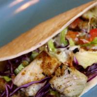 Tilapia Tacos · Two soft tacos with grilled, seasoned tilapia, lettuce, tomatoes, and our chef’s creamy jala...