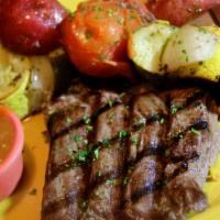 Bistec A La Parrilla · Hickory grilled rib-eye steak, marinated to perfection and served with our homemade tomato c...