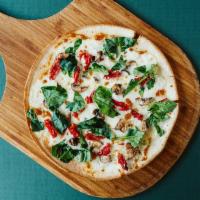 Sun & Shade Pizza · Sundried tomatoes, mushrooms, and mozzarella on an alfredo sauce base. Finished with fresh b...
