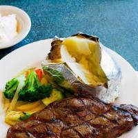 Rib Eye Steak Dinner · Topped with grilled onions and mushrooms, served with mixed vegetables and mashed potatoes a...