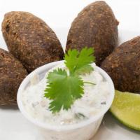 Kibbeh · Beef croquettes made with finely ground meat, cracked wheat, mint leaves, pine nuts, onions ...