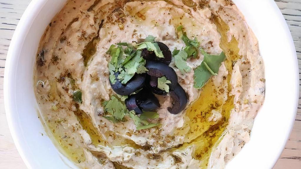 Baba Ghanouj · Grilled eggplant purée and mixed with tahini and lemon juice ~ served with pita bread