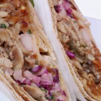 Chicken Shawarma · Roasted thin slices of marinated chicken breast with pickled vegetables, wrapped in a warm p...