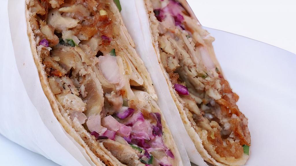 Chicken Shawarma · Roasted thin slices of marinated chicken breast with pickled vegetables, wrapped in a warm pita bread ~ served with garlic sauce