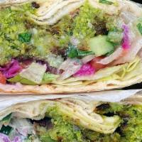 Falafel Pita · Crispy hot falafel, surrounded by cool and crunchy diced tomatoes, cucumbers, and onions, an...
