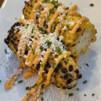 Esquites · Chargrilled Mexican street corn served on the cob, with chipotle aioli, chives, cotija cheese.