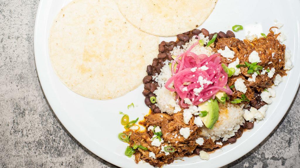Cochinita Pibil · Traditional slow-roasted pulled pork | black beans, jasmine rice, achiote pulled pork, sweet plantains, avocado, pickled onion, queso fresco, served with corn tortillas.