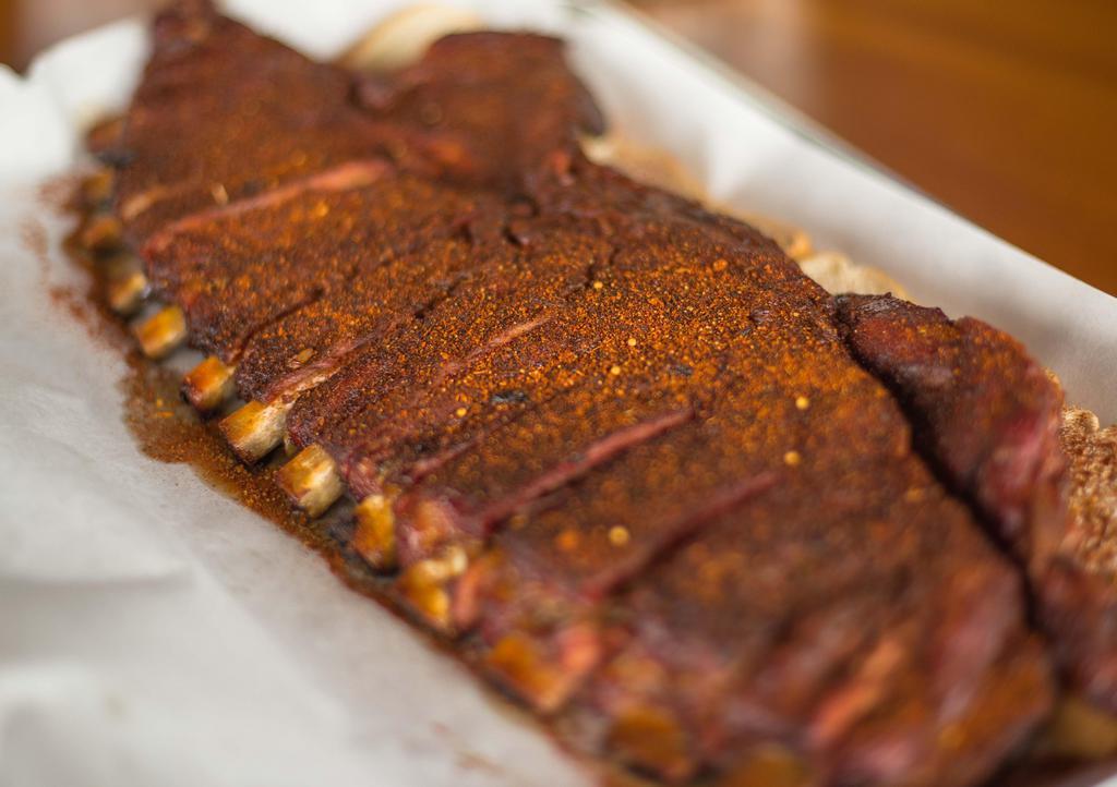 Full Rack Smoked Spare Ribs · 1 Pint each of Mac & Cheese, Baked Beans & Slaw, 10 Hushpuppies, 1 Gallon Iced Tea, & BBQ Sauce
